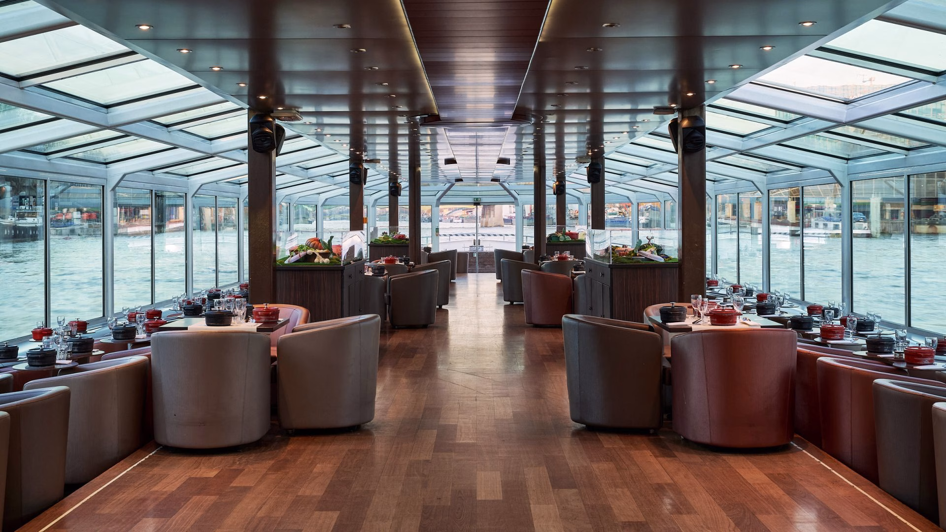 Salle de restaurant panoramique avec vue sur l'eau lors d'un diner croisière élégant sur la Seine | Paris en Scène